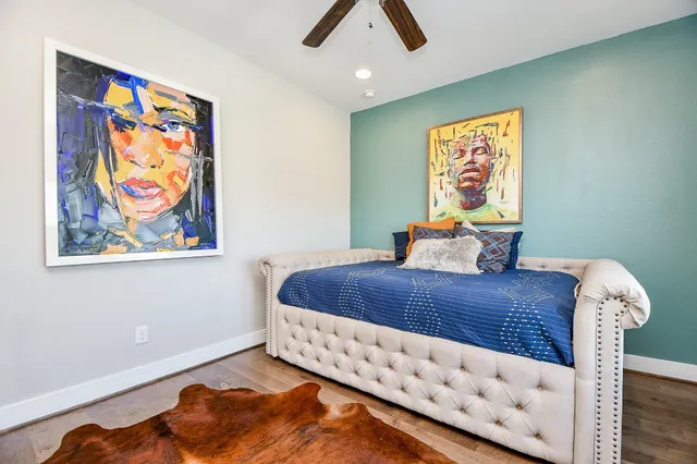 a bed sitting in a bedroom next to a window