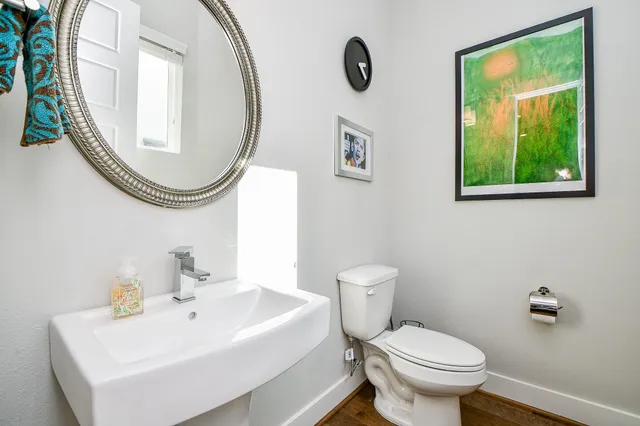 a white toilet sitting next to a bathroom sink
