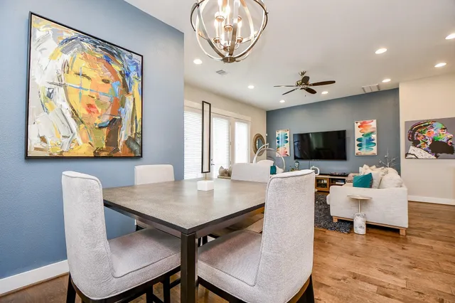 a living room with furniture a clock and a chandelier