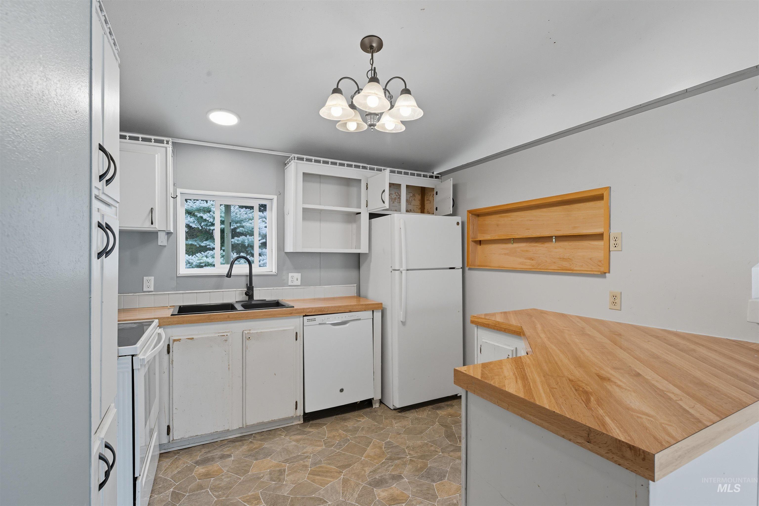 609 North Almon Street, Unit 2003 Moscow, ID 83843 - Photo 11 of 18 Kitchen featuring white cabinets, open shelves, white appliances, and wood counters