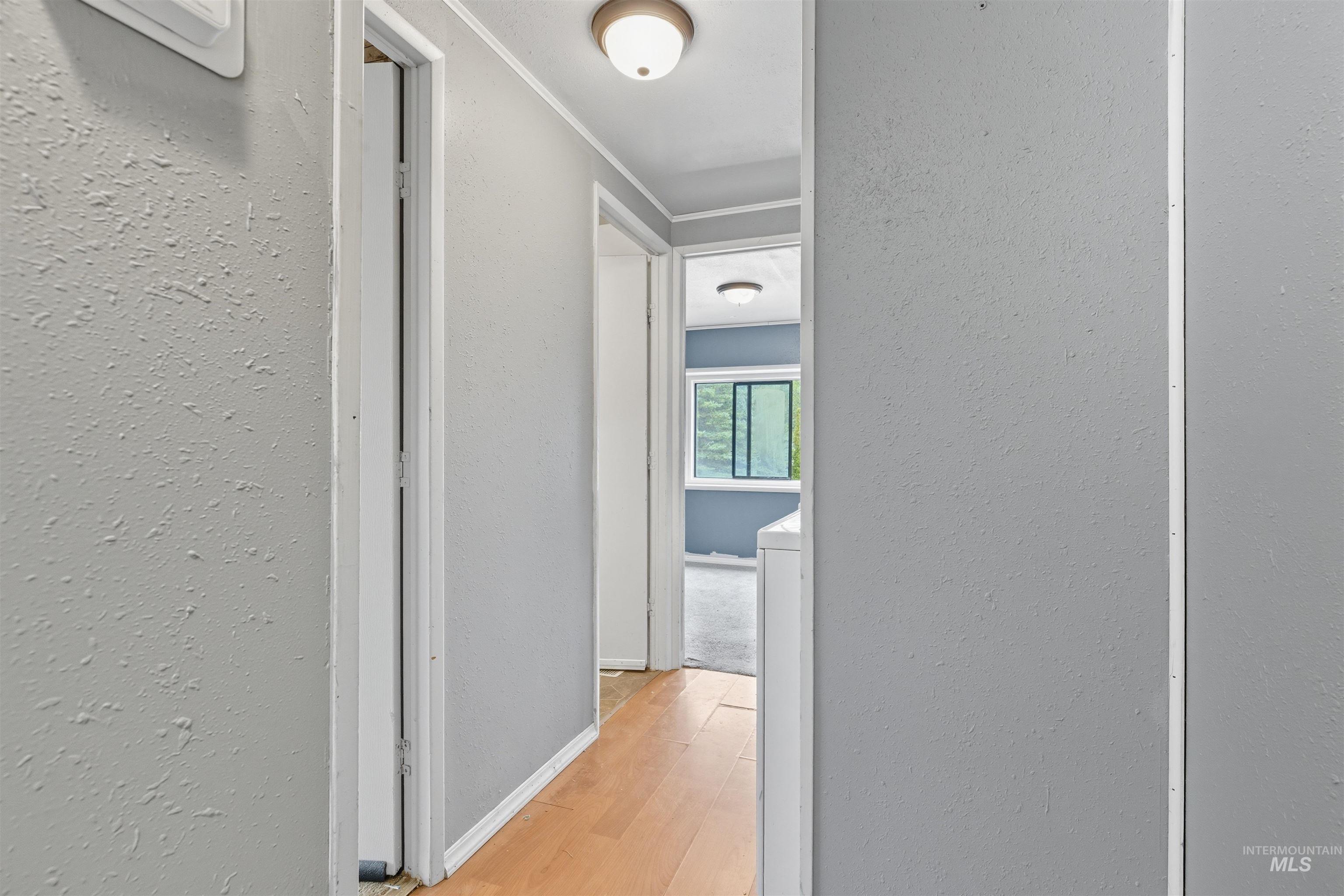 609 North Almon Street, Unit 2003 Moscow, ID 83843 - Photo 3 of 18 Hall featuring light wood-style floors and a textured wall