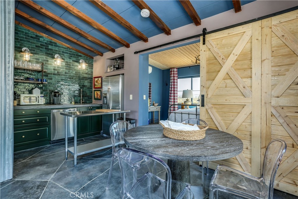 a dining room with a wooden table and chairs