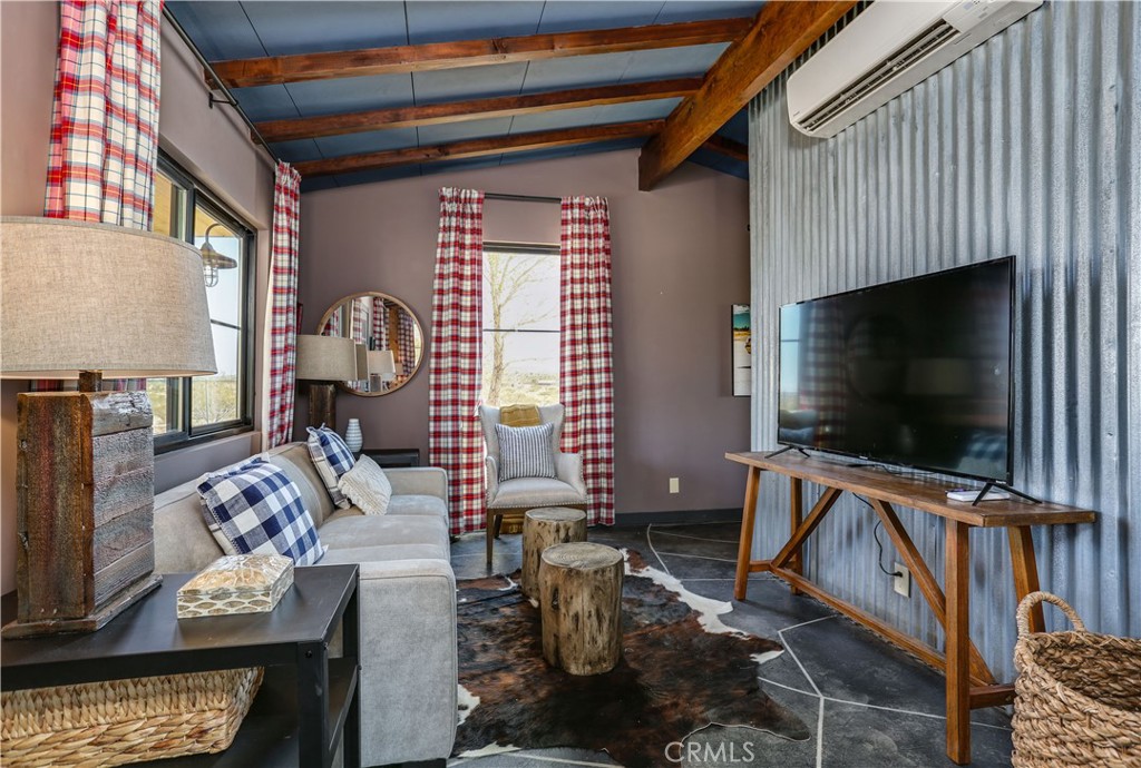5969 Lorraine Road Yucca Valley, CA 92285 - Photo 13 of 45 a living room with furniture and a flat screen tv