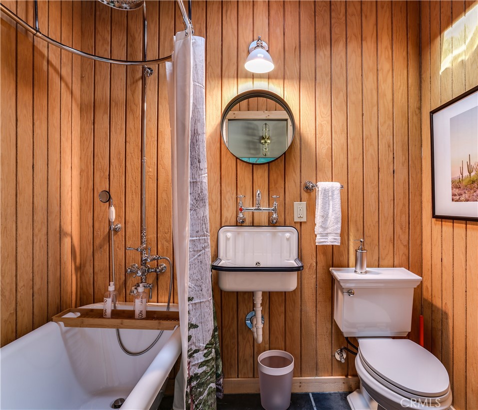 5969 Lorraine Road Yucca Valley, CA 92285 - Photo 25 of 45 a bathroom with a granite countertop toilet and a sink