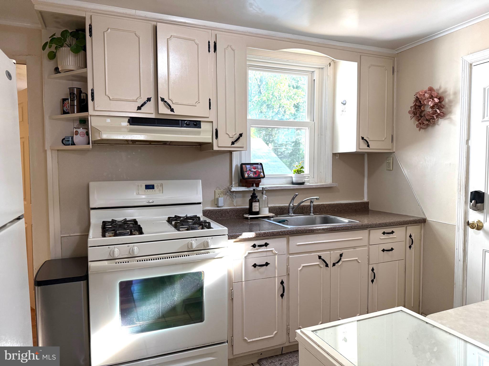 1510 Wynnewood Road Ardmore, PA 19003 - Photo 6 of 20 a kitchen with stainless steel appliances a stove a sink and a microwave