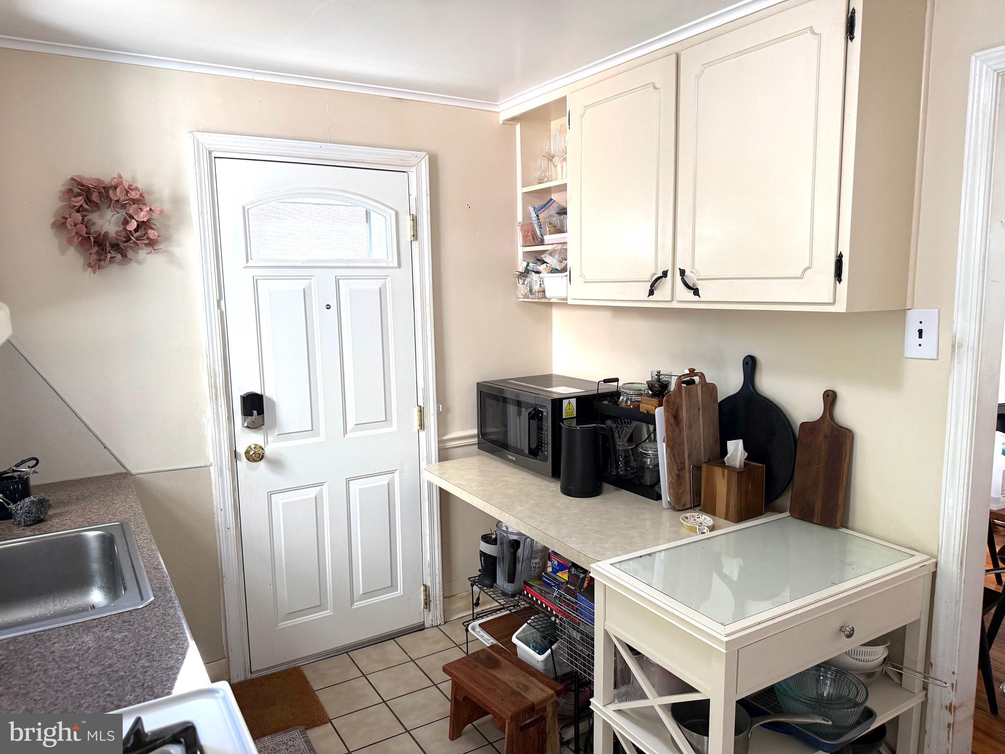 1510 Wynnewood Road Ardmore, PA 19003 - Photo 7 of 20 a kitchen with stainless steel appliances a sink a refrigerator and a cabinets