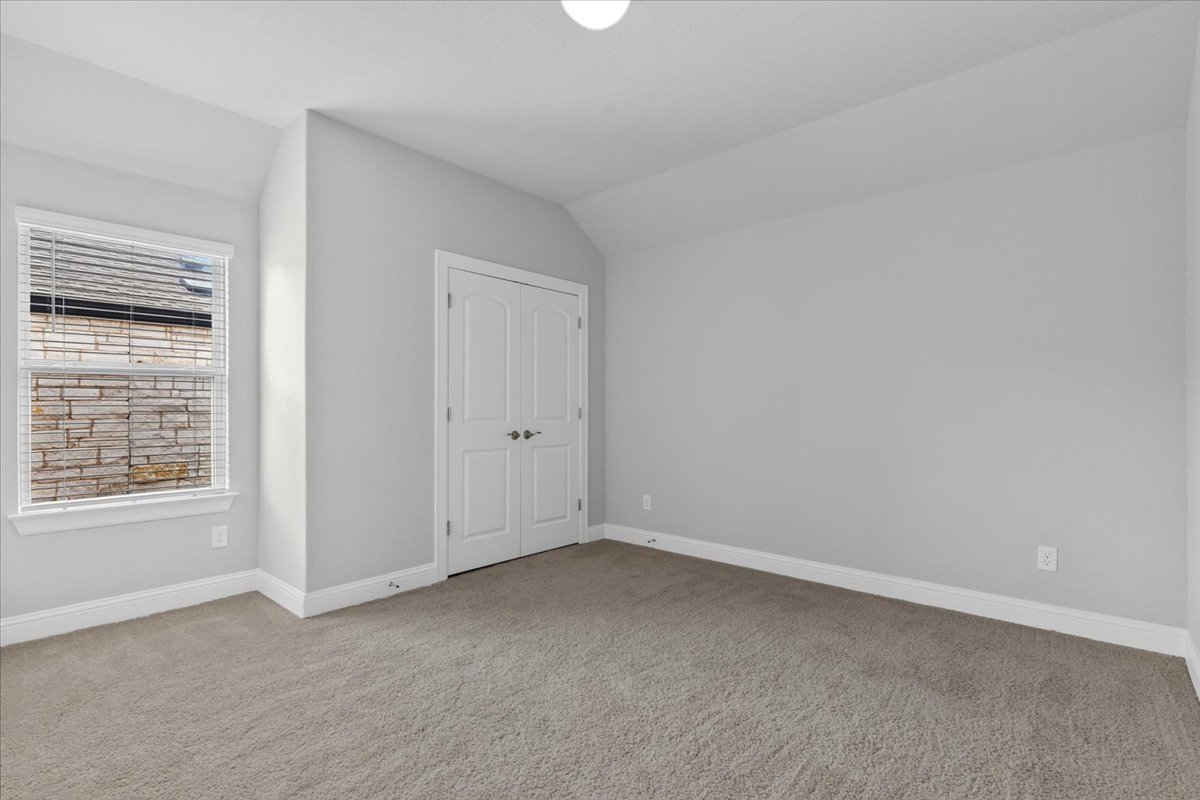 109 Rocky River Road Georgetown, TX 78628 - Photo 26 of 37 A quiet bedroom with vaulted ceilings offers a bright and comfortable retreat.