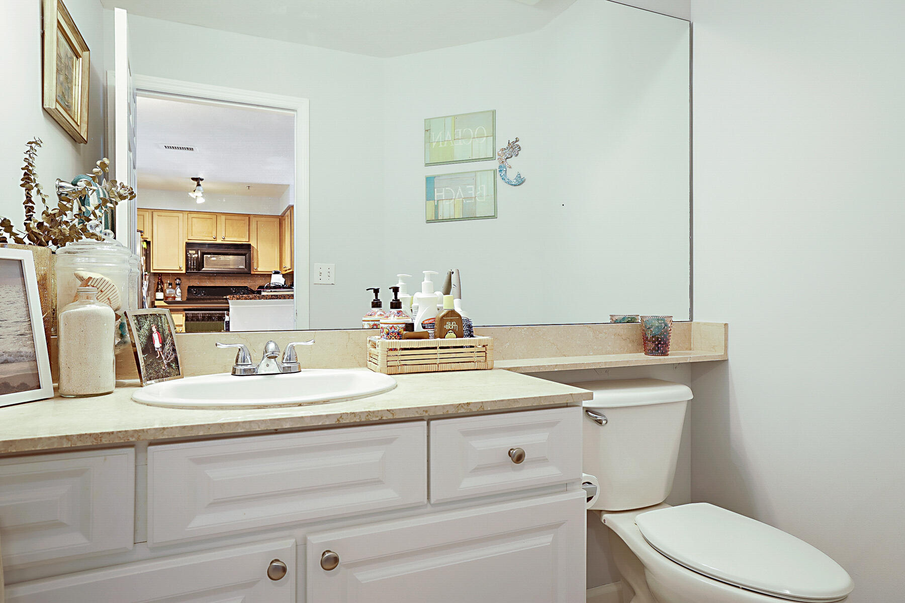 175 Galicia Way, Unit 210 Jupiter, FL 33458 - Photo 12 of 17 a bathroom with a sink a toilet and mirror