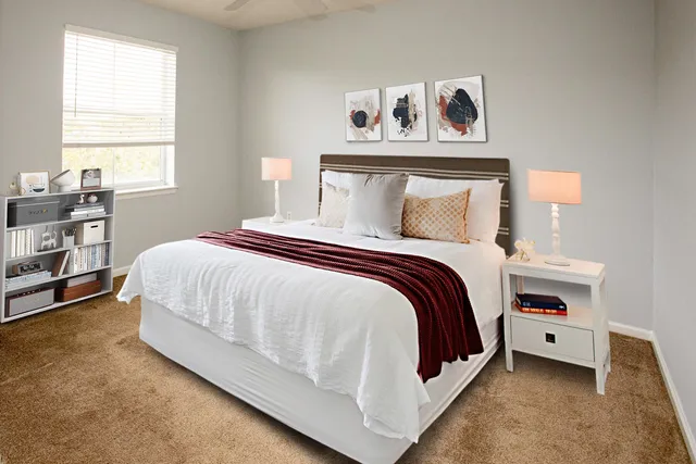 a bedroom with a bed and a window