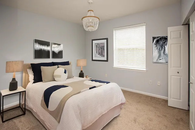 a bedroom with bed and a window