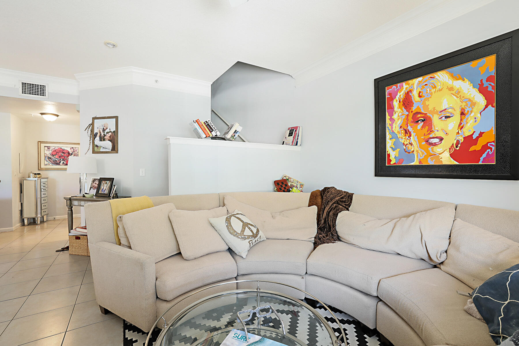 175 Galicia Way, Unit 210 Jupiter, FL 33458 - Photo 4 of 17 a living room with furniture and wall paintings