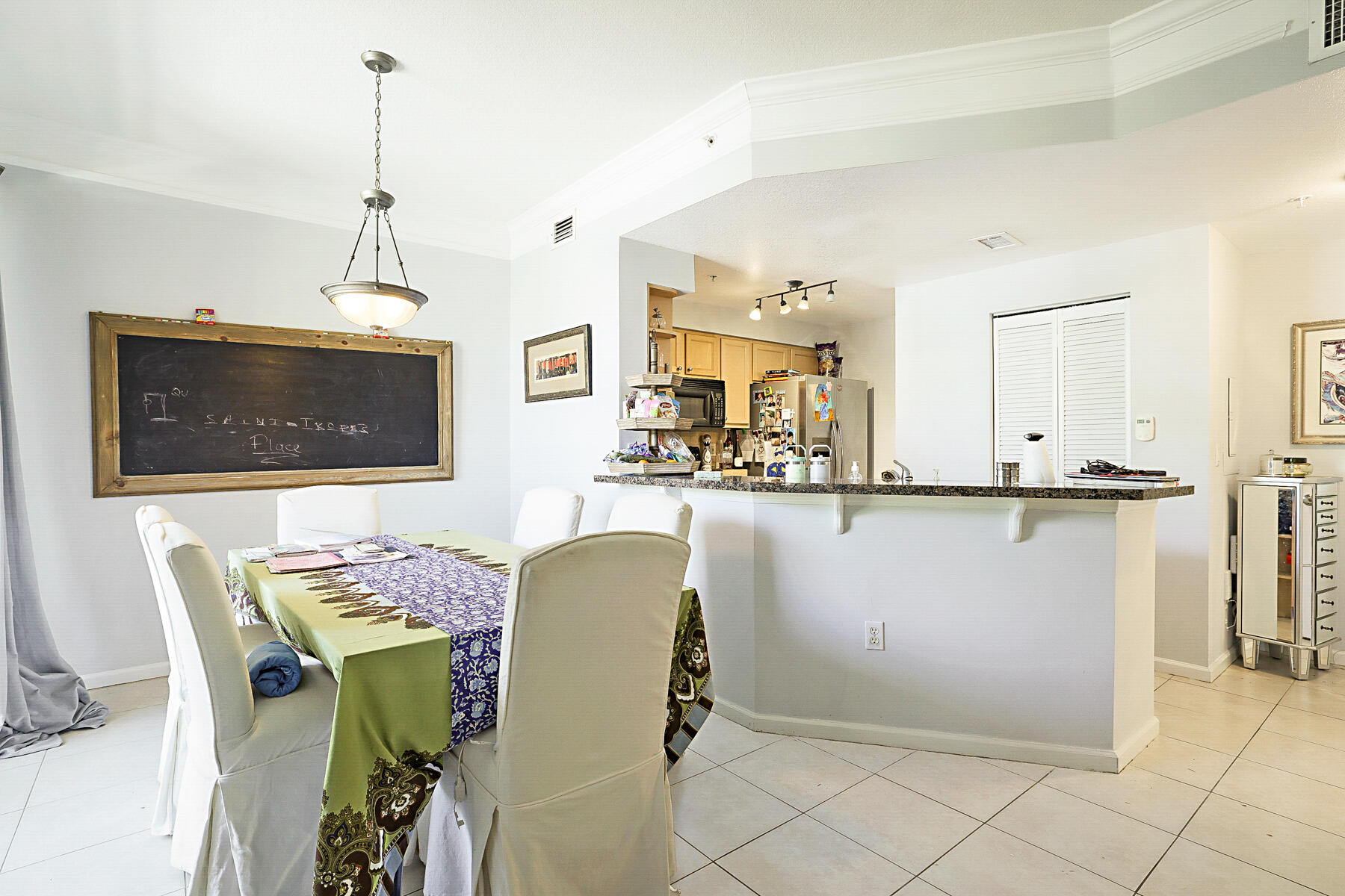 175 Galicia Way, Unit 210 Jupiter, FL 33458 - Photo 6 of 17 a view of a dining room with furniture and chandelier