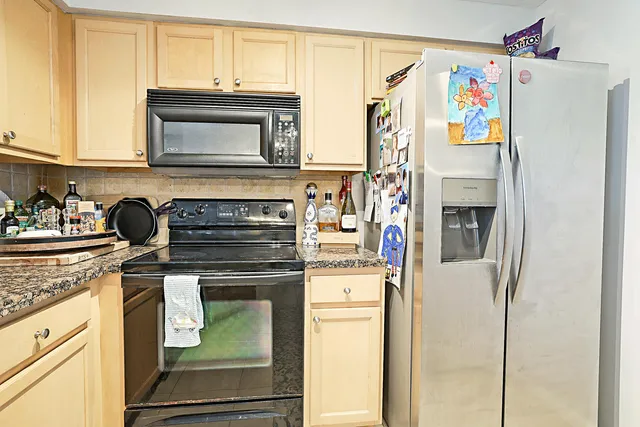 a kitchen with stainless steel appliances granite countertop a stove and a refrigerator