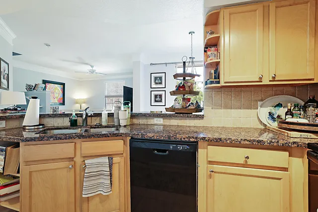 a kitchen with granite countertop stainless steel appliances a sink and cabinets
