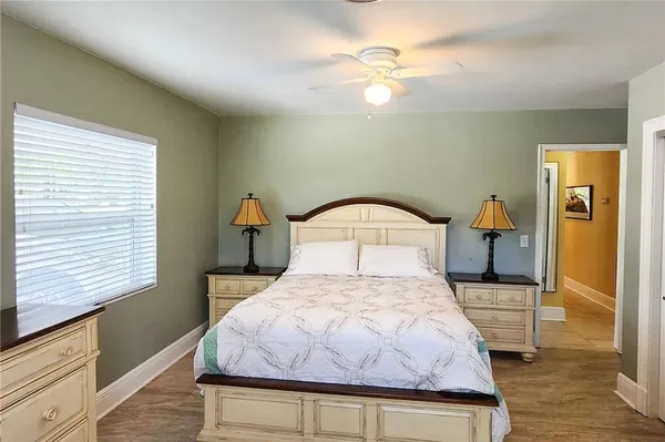 a bedroom with a bed and a chandelier