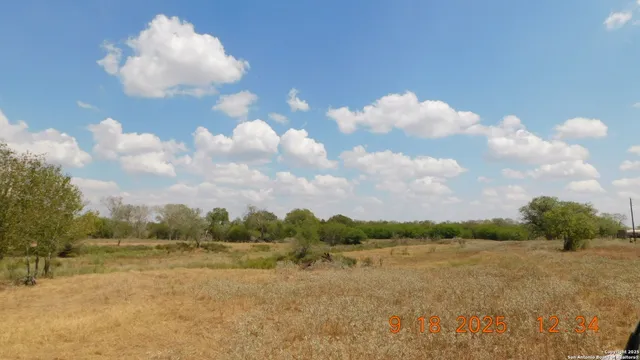 a front view of a house with a yard covered with snow