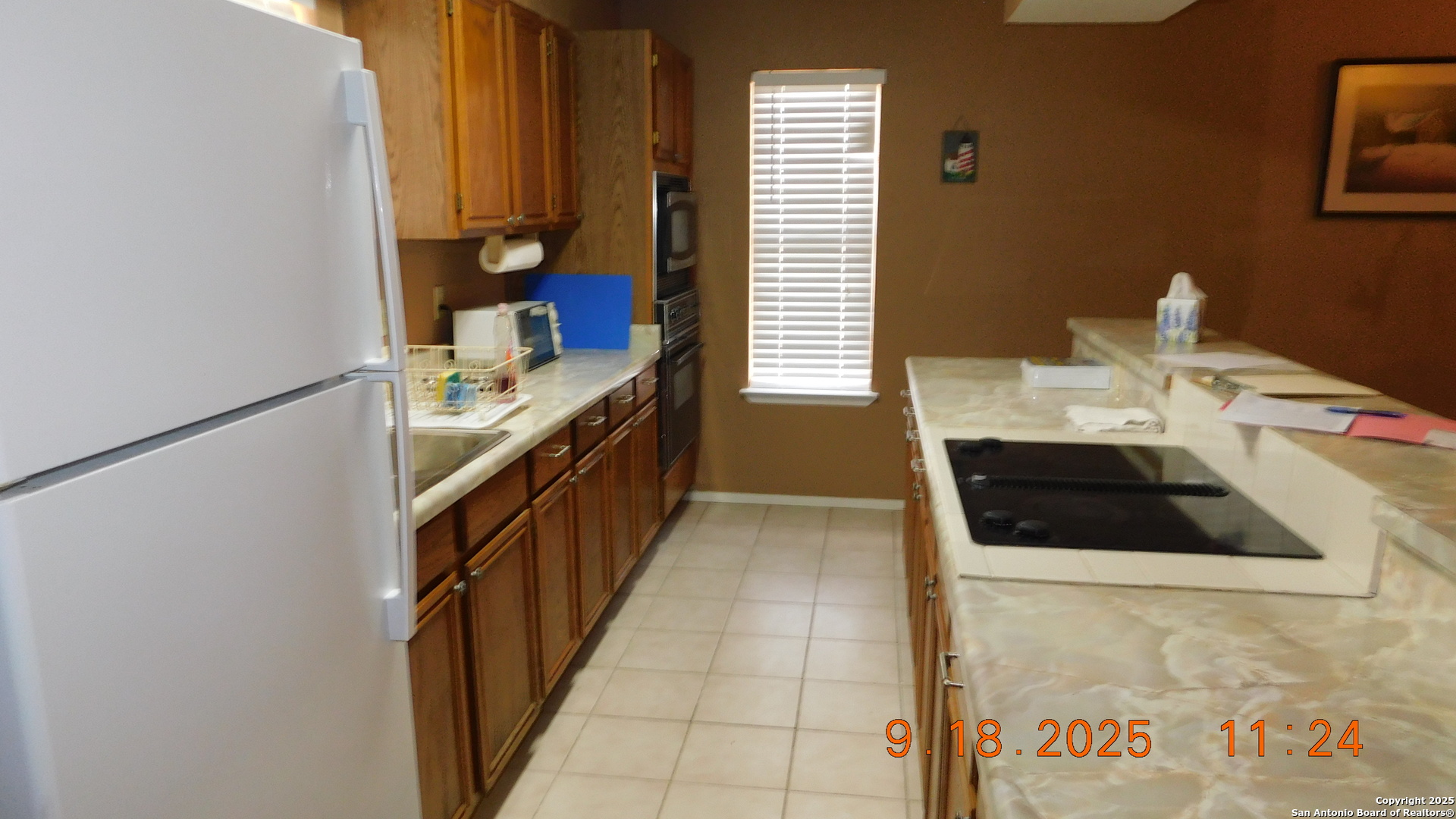 3 Gansky Lane Pleasanton, TX 78064 - Photo 32 of 45 a kitchen with a sink a stove and a refrigerator