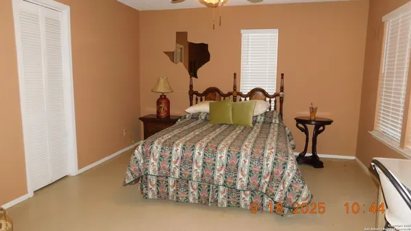 a bedroom with a bed and a chair