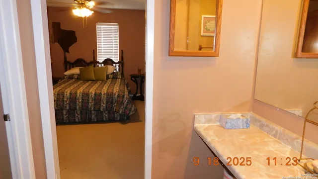 a view of staircase with railing and a chandelier