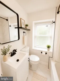 a bathroom with a sink toilet a mirror and shower
