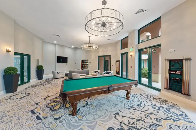 a room with pool table and windows