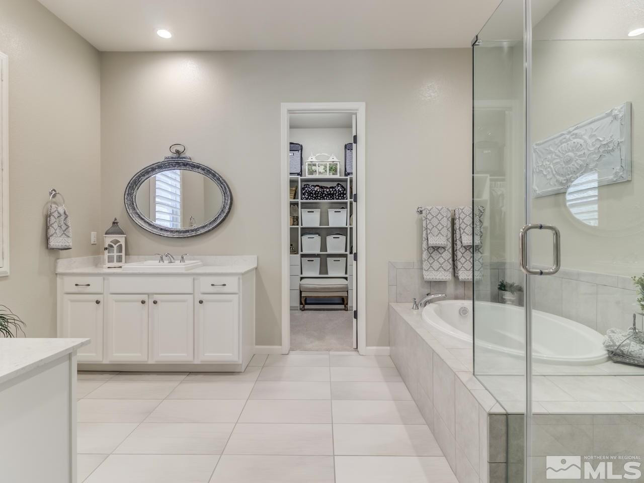 9465 Baldacci Road Reno, NV 89521 - Photo 14 of 25 a spacious bathroom with a tub sink and mirror