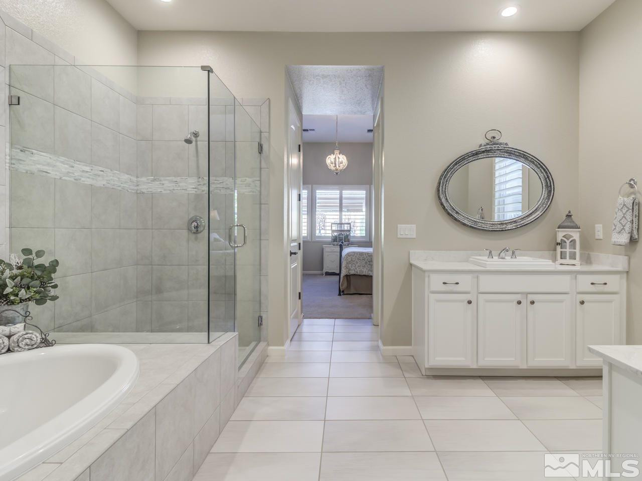 9465 Baldacci Road Reno, NV 89521 - Photo 16 of 25 a spacious bathroom with a bathtub shower sink and mirror