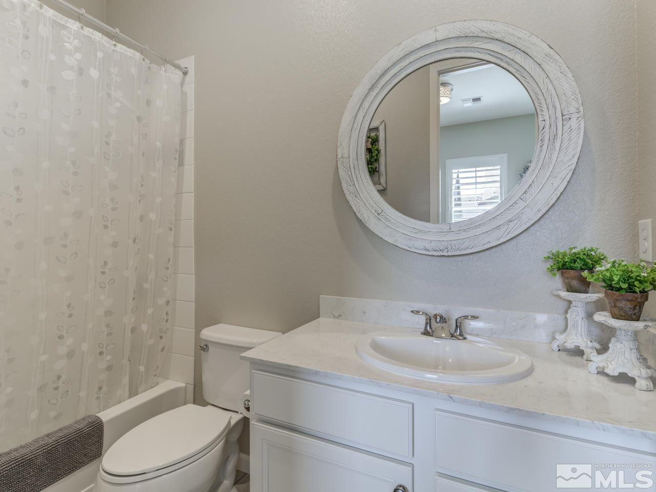 9465 Baldacci Road Reno, NV 89521 - Photo 19 of 25 a bathroom with a sink toilet and mirror