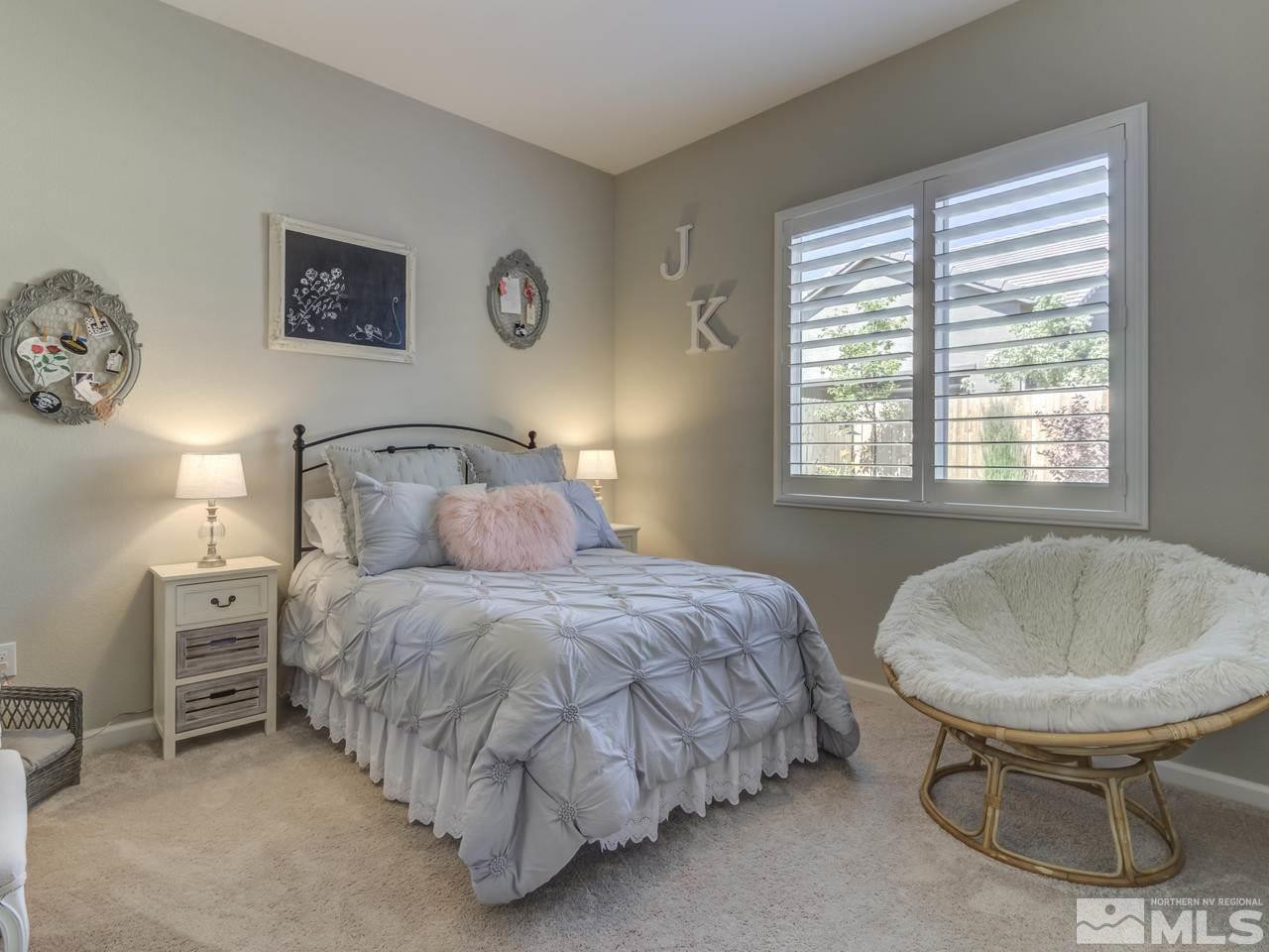 9465 Baldacci Road Reno, NV 89521 - Photo 20 of 25 a bedroom with a bed and a table in it