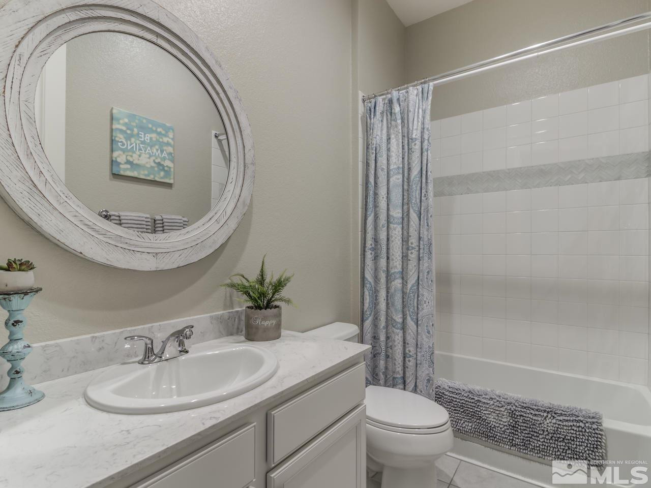 9465 Baldacci Road Reno, NV 89521 - Photo 22 of 25 a bathroom with a sink a toilet and a mirror