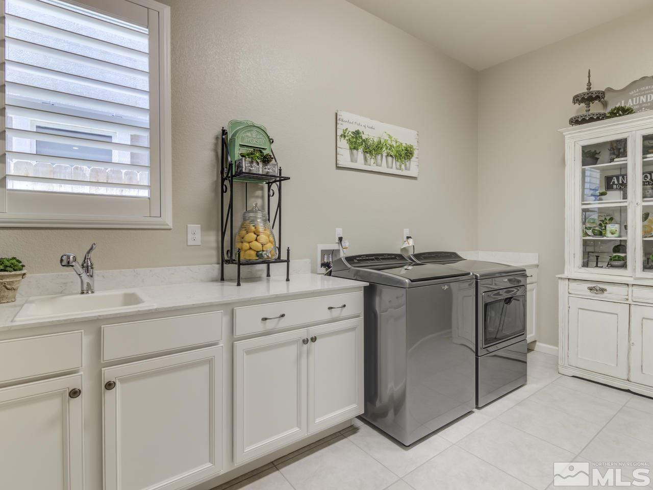 9465 Baldacci Road Reno, NV 89521 - Photo 24 of 25 a kitchen with stainless steel appliances granite countertop a sink and a stove next to a window