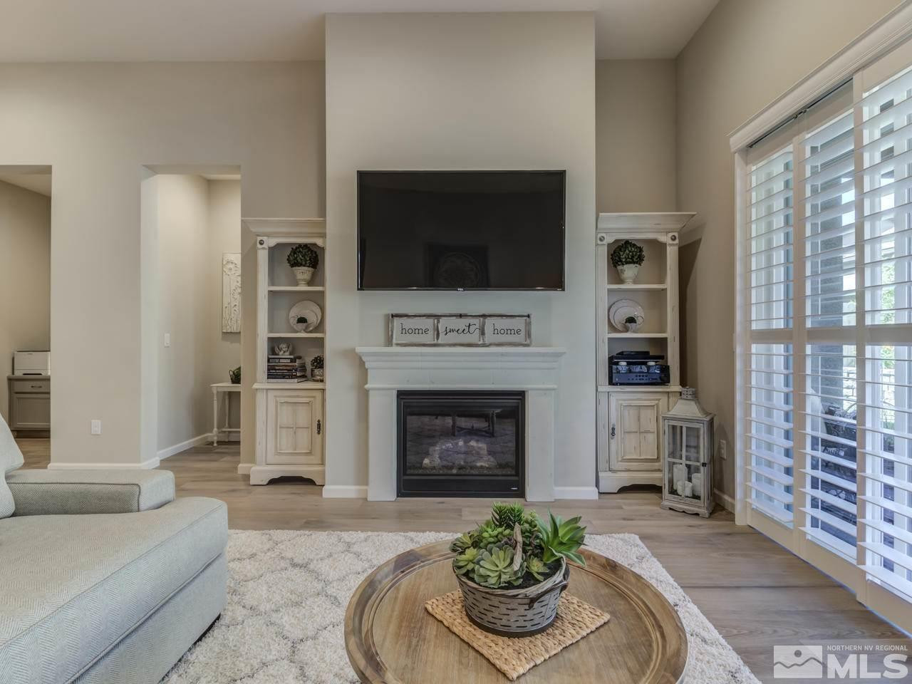 9465 Baldacci Road Reno, NV 89521 - Photo 10 of 25 a living room with furniture a flat screen tv and a fireplace
