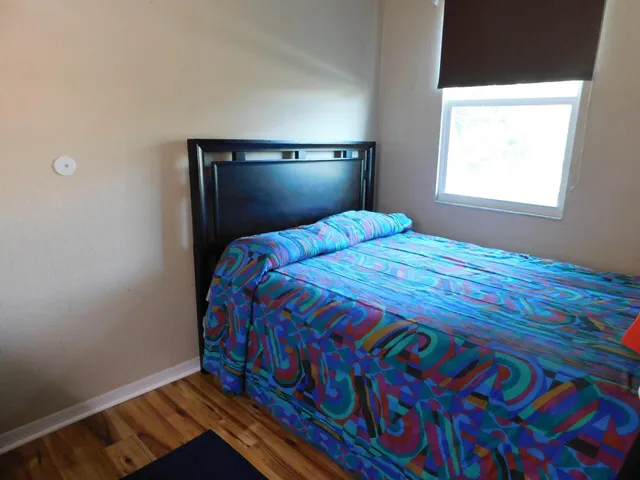 a bedroom with a bed and a window