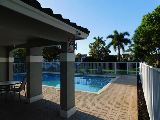 a view of a backyard with swimming pool