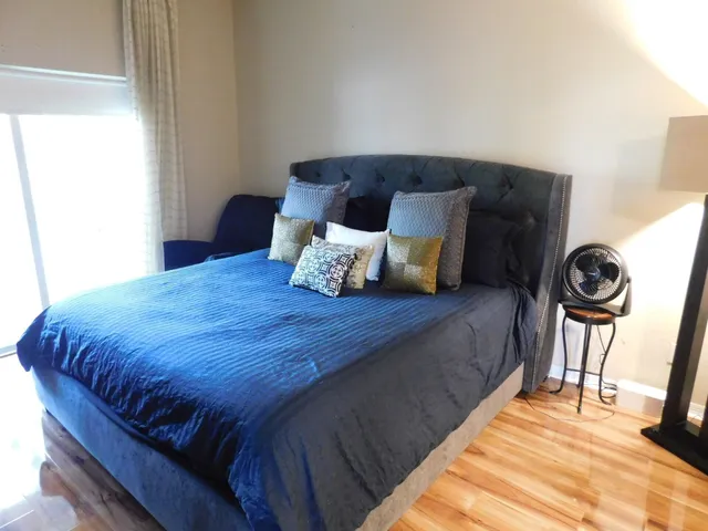 a bedroom with a bed and a window