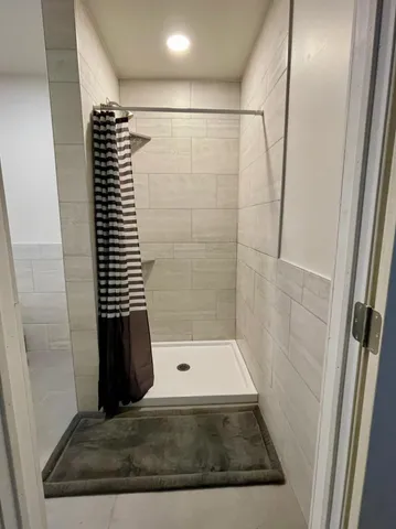 a bathroom with a shower and a toilet