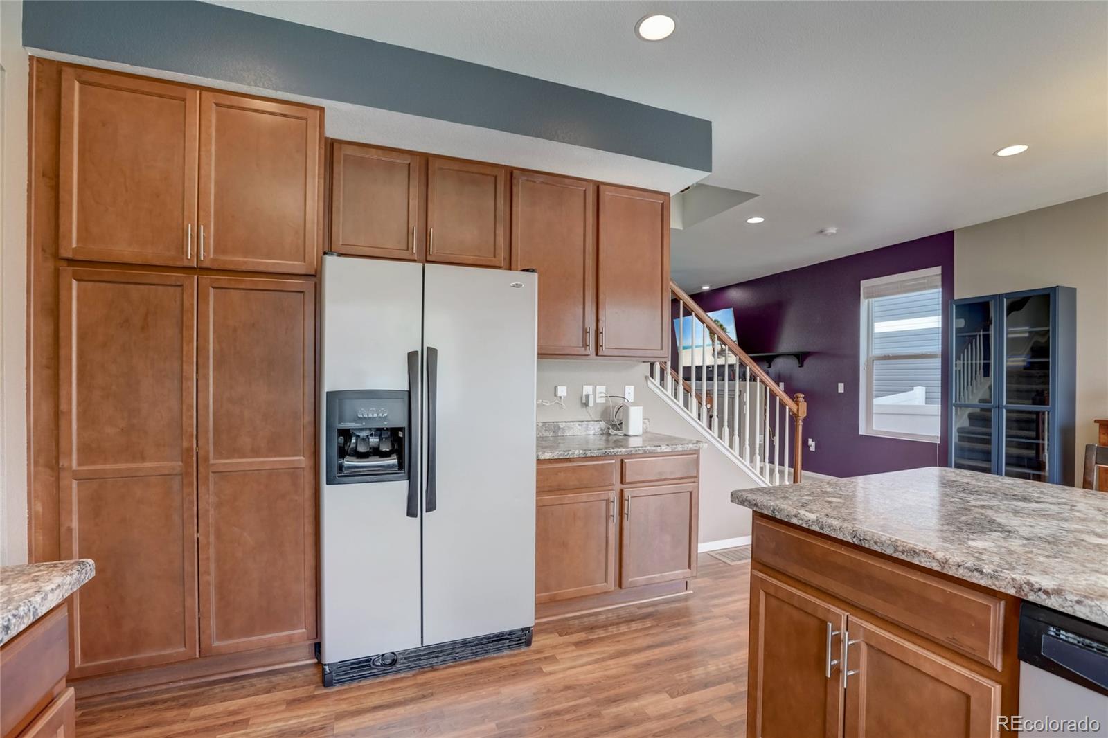 5545 Liverpool Street Denver, CO 80249 - Photo 14 of 40 a kitchen with granite countertop a refrigerator and a sink