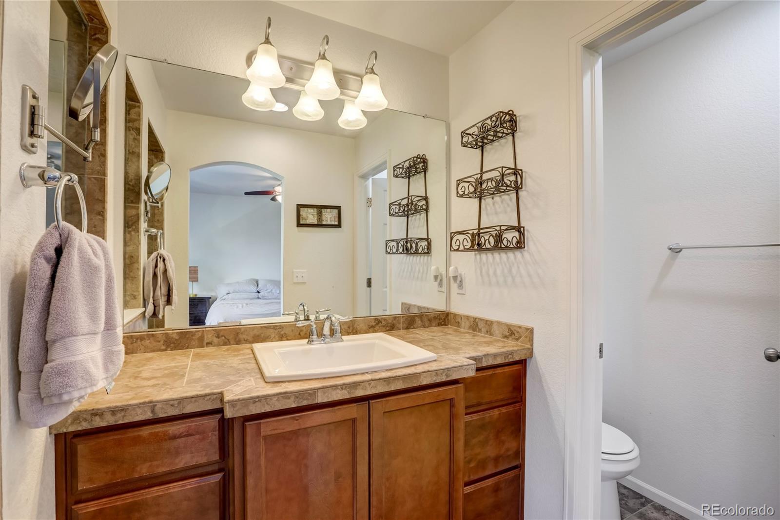 5545 Liverpool Street Denver, CO 80249 - Photo 17 of 40 a bathroom with a sink and a mirror