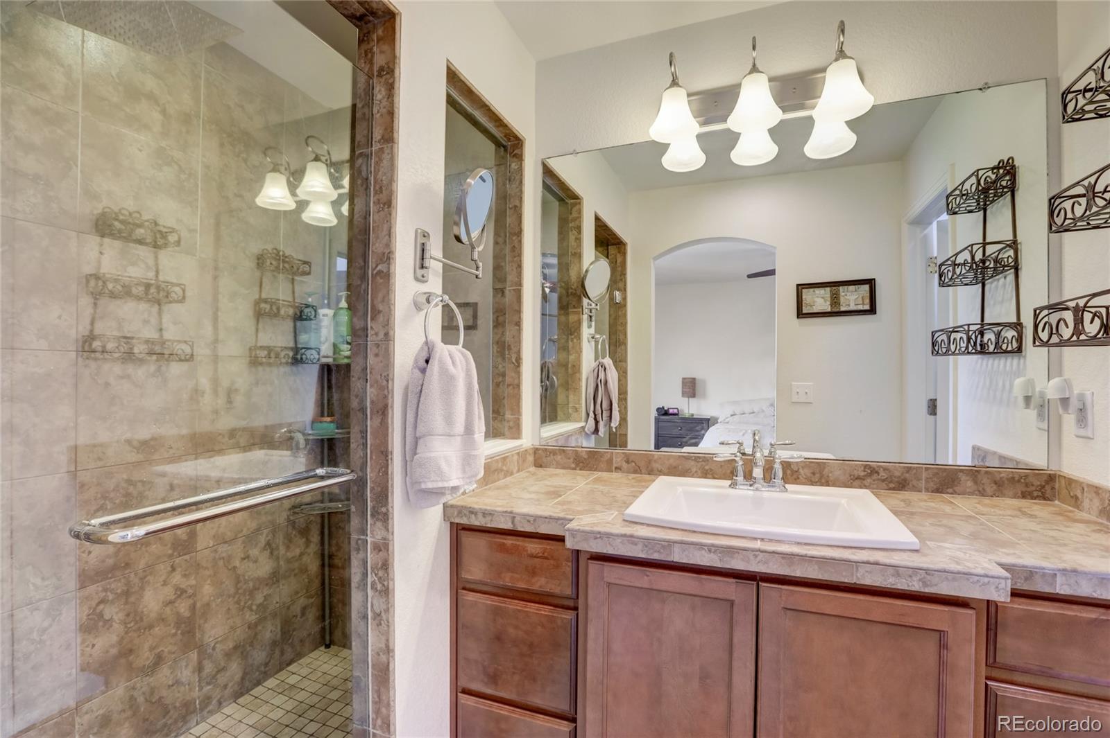 5545 Liverpool Street Denver, CO 80249 - Photo 18 of 40 a bathroom with a sink and a mirror