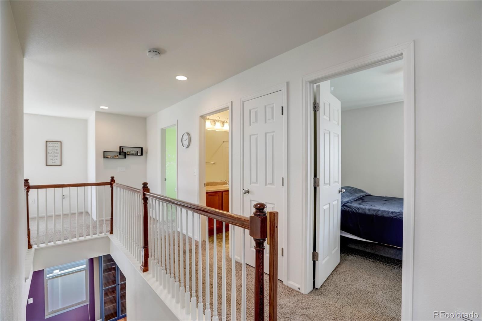 5545 Liverpool Street Denver, CO 80249 - Photo 19 of 40 a view of a hallway to a livingroom with furniture