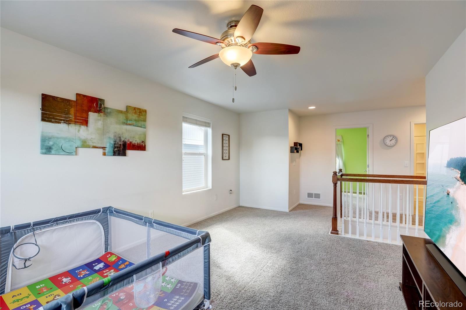 5545 Liverpool Street Denver, CO 80249 - Photo 22 of 40 a bedroom with furniture and a window