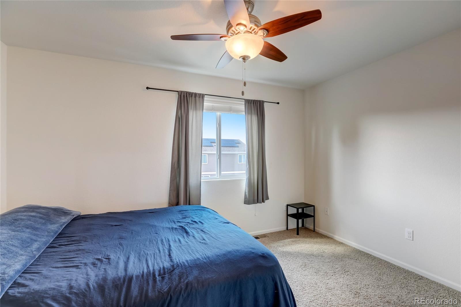 5545 Liverpool Street Denver, CO 80249 - Photo 24 of 40 a bedroom with a bed and a window
