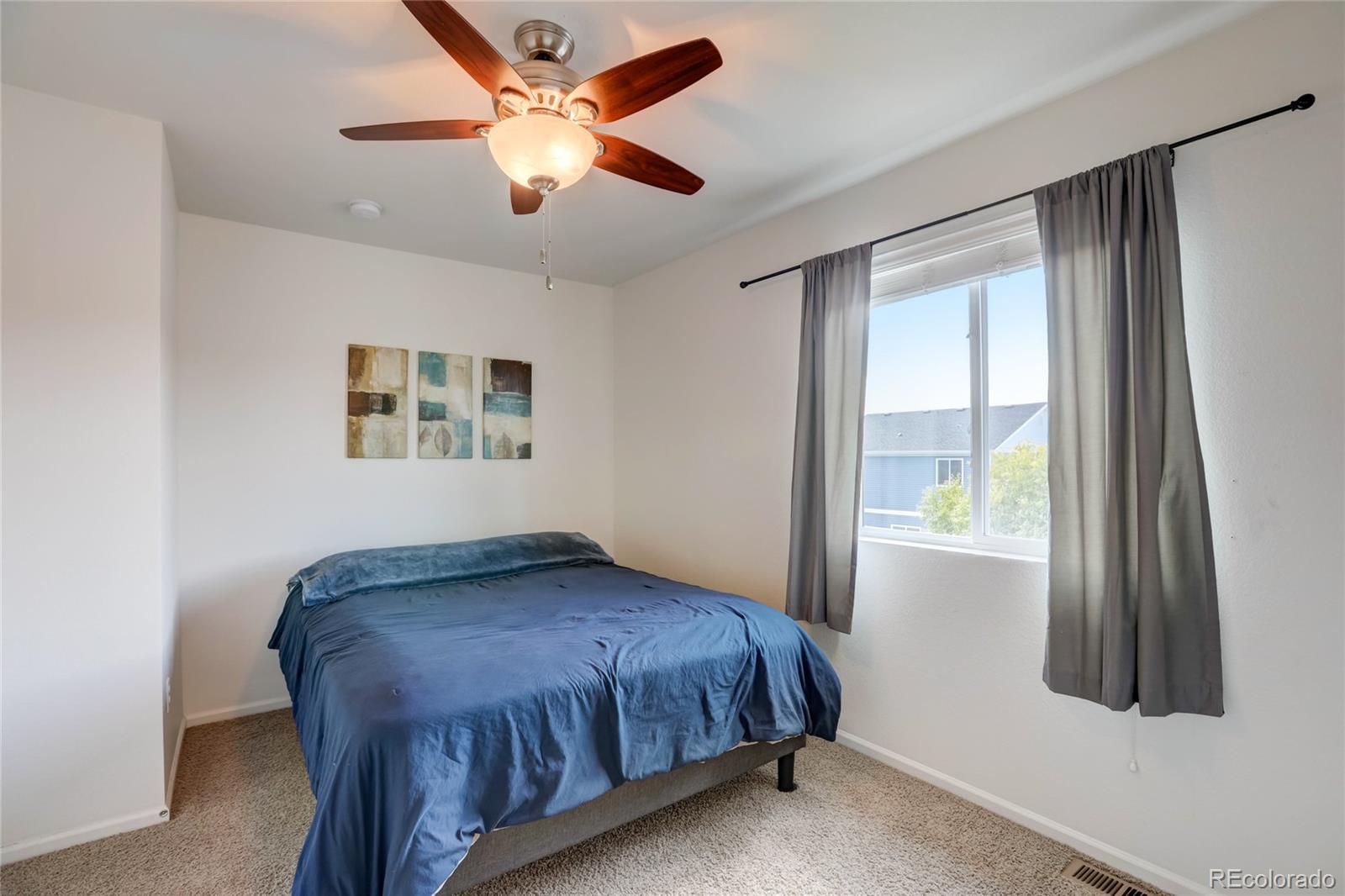 5545 Liverpool Street Denver, CO 80249 - Photo 25 of 40 a bedroom with a bed and a window