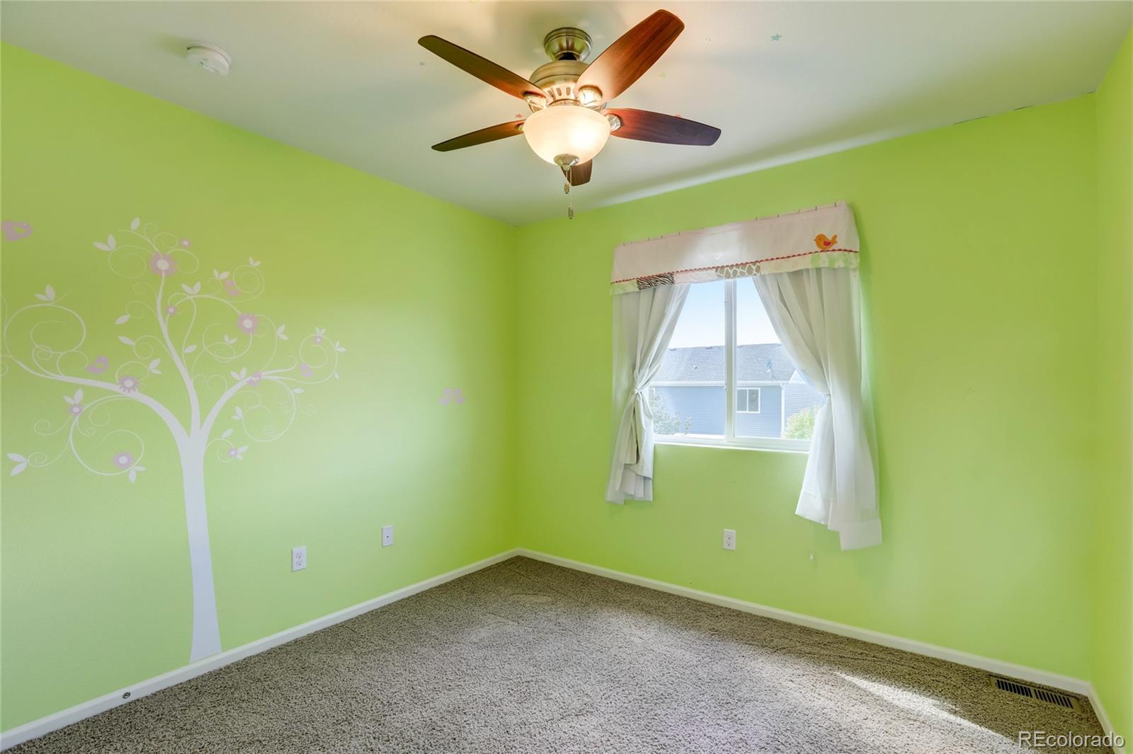 5545 Liverpool Street Denver, CO 80249 - Photo 27 of 40 an empty room with a window and ceiling fan