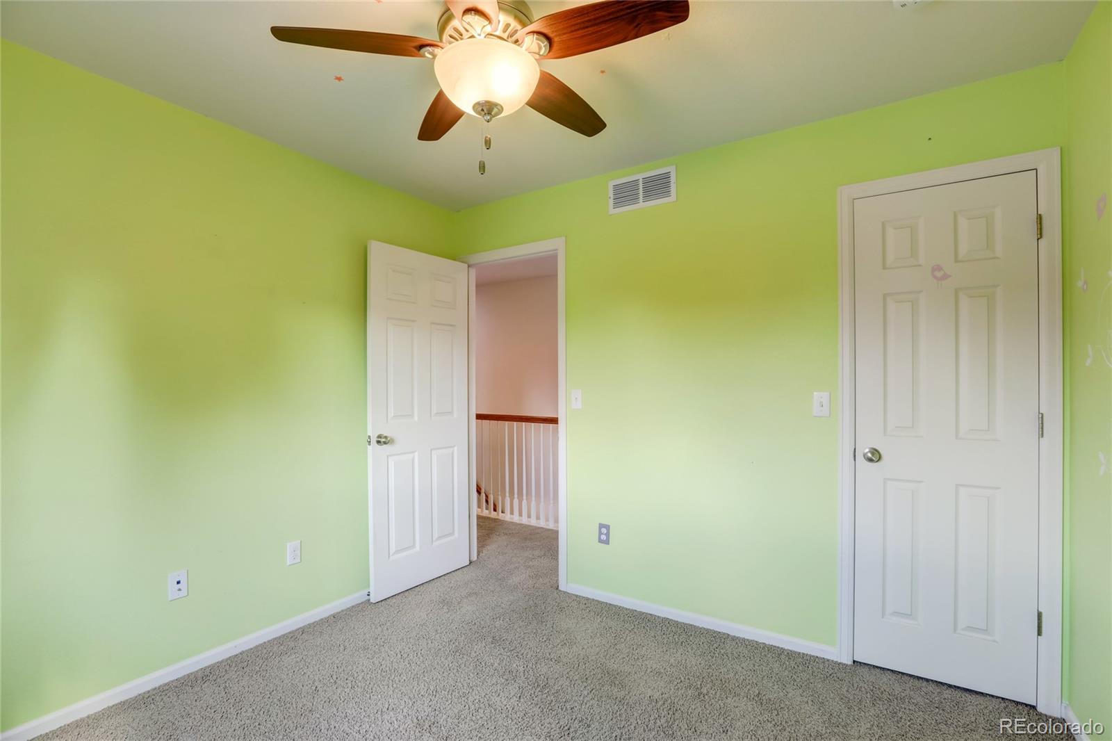 5545 Liverpool Street Denver, CO 80249 - Photo 28 of 40 en view of a hallway with a chandelier fan
