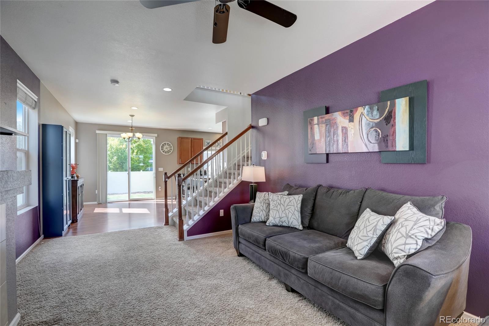 5545 Liverpool Street Denver, CO 80249 - Photo 3 of 40 a living room with furniture and a ceiling fan