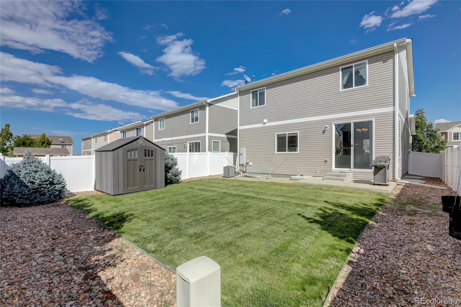 5545 Liverpool Street Denver, CO 80249 - Photo 36 of 40 a house that has garden in front of it