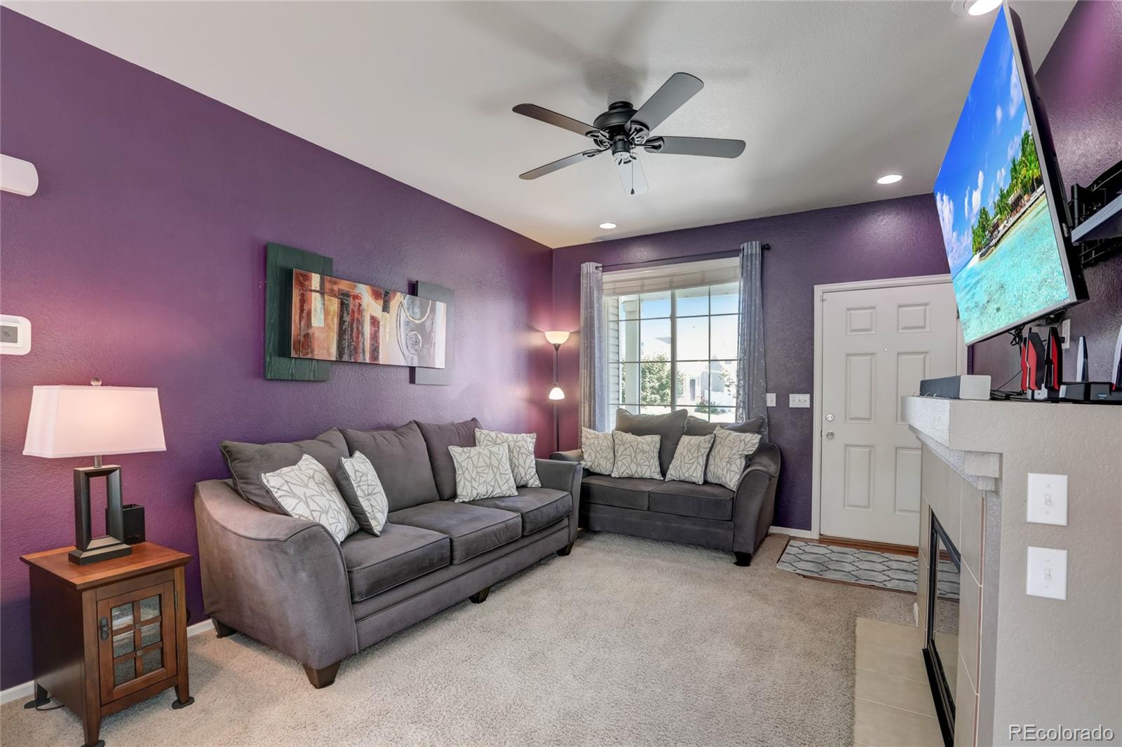 5545 Liverpool Street Denver, CO 80249 - Photo 5 of 40 a living room with furniture and a flat screen tv