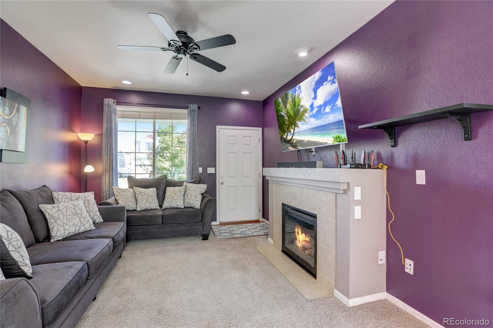 5545 Liverpool Street Denver, CO 80249 - Photo 6 of 40 a living room with furniture and a fireplace