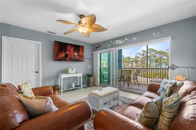 a living room with furniture large window and a flat screen tv